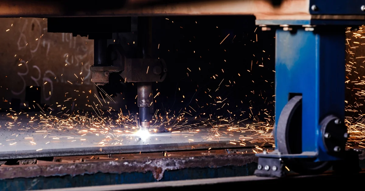 Plasma cutter slicing metal sheet